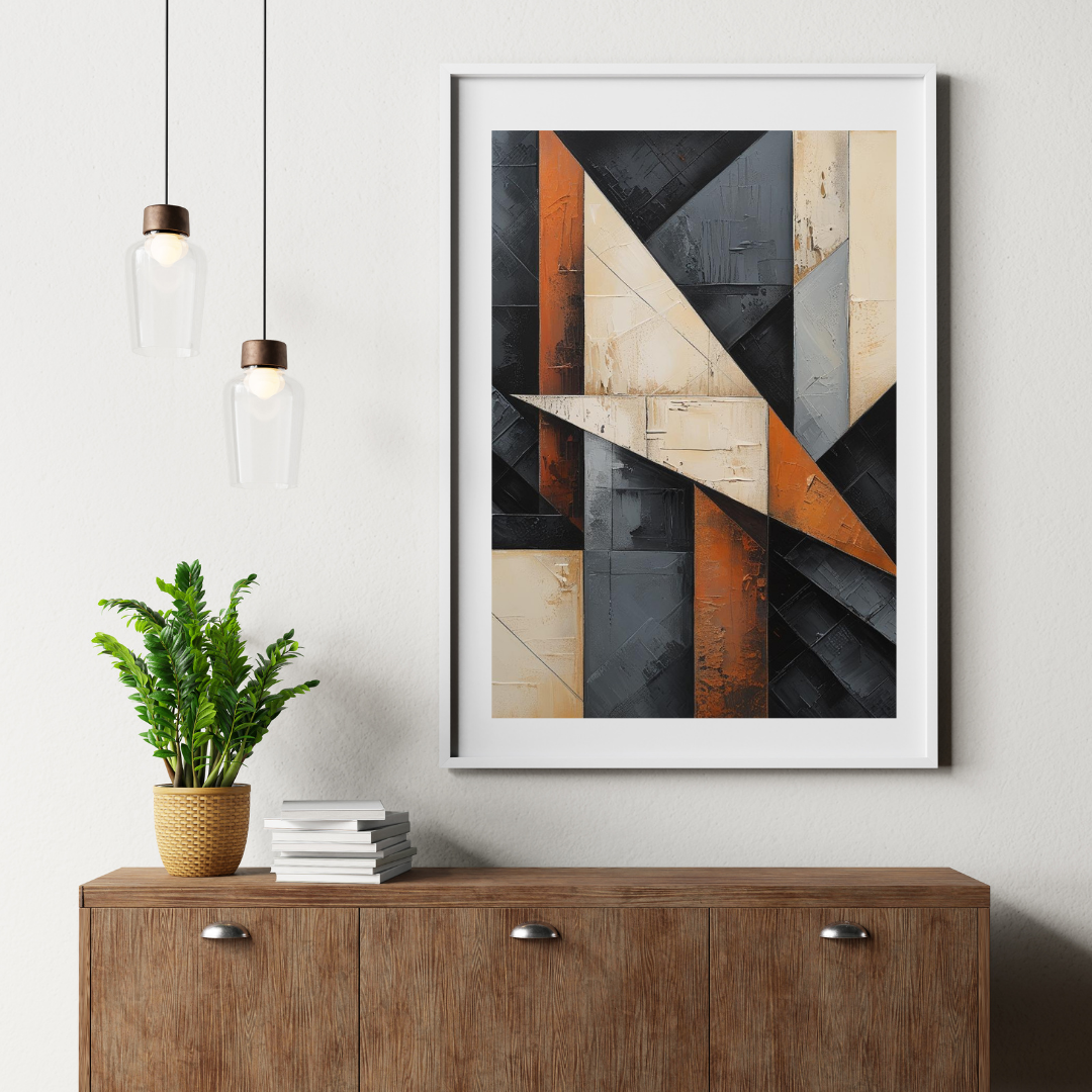 Abstract art print on a wall above a wooden cabinet with a plant and books.