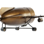 Bronze-colored metal object resembling a vintage airplane on a white background