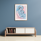 Framed artwork of a mother and child on a blue wall above a wooden shelf.