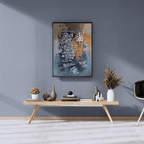Modern interior with a wooden console table against a gray wall, featuring decorative items and a framed artwork.