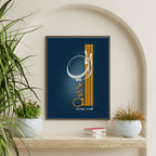 Framed artwork with Arabic calligraphy on a wall with plants and books below.