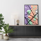 Abstract art piece on a wall above a console table with plants and decor.