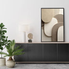Modern interior design with abstract art, plants, and decorative items on a console table.