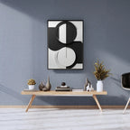 Modern interior design with abstract wall art, a wooden console table, and decorative items against a gray wall.