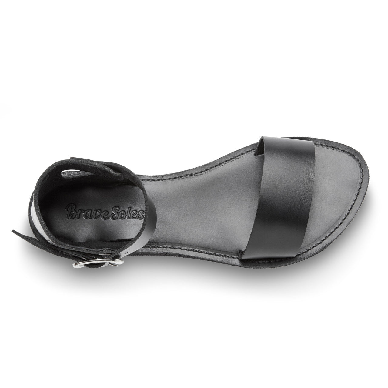 Black sandal with a strap on a white background
