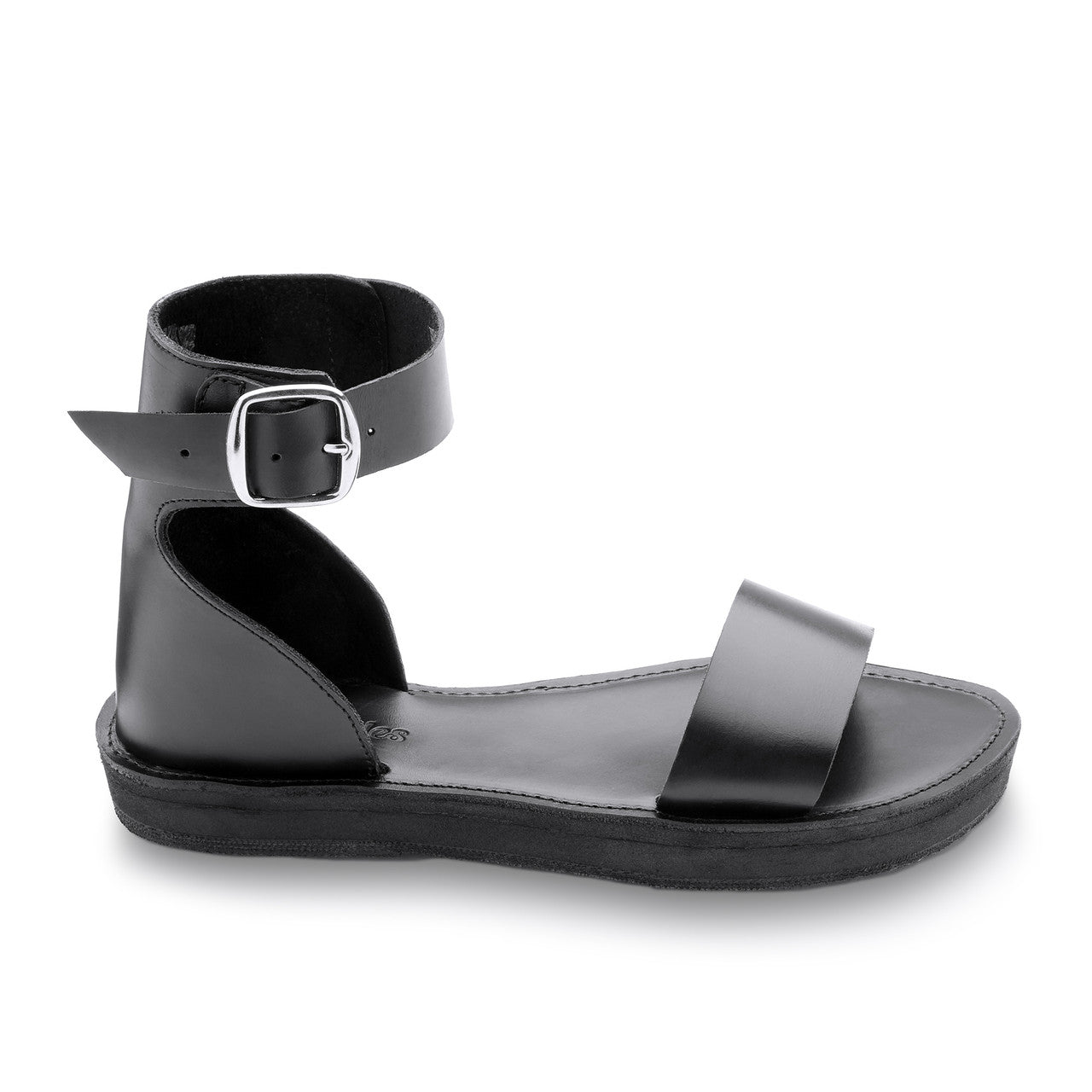 Black sandal with a buckle on a white background