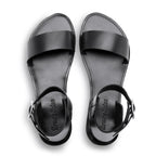 Black sandals with 'Brunello Cucinelli' branding on a white background