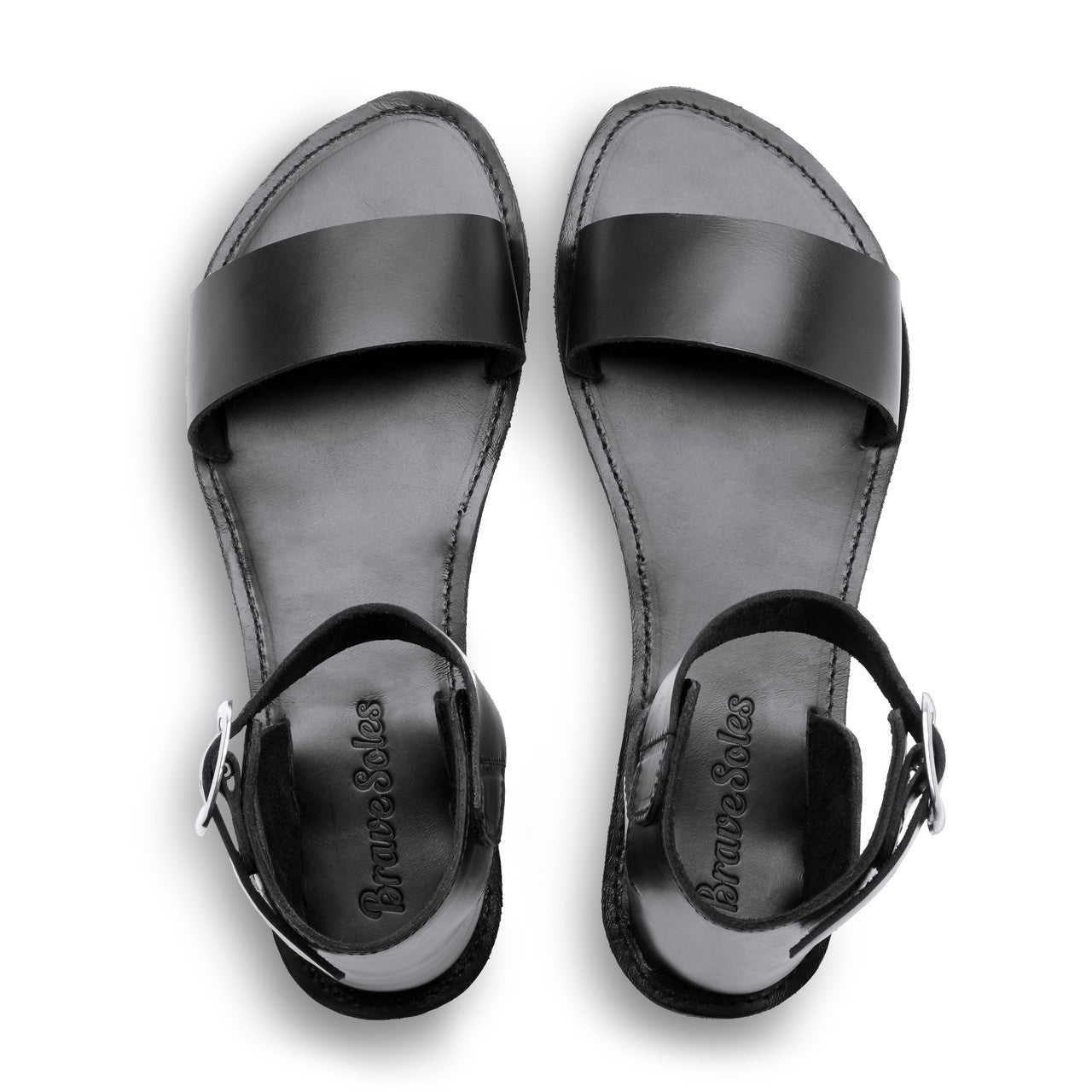 Black sandals with 'Brunello Cucinelli' branding on a white background