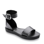 Black sandal with a buckle on a white background