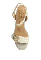 Gold sandal with lace detail on a white background