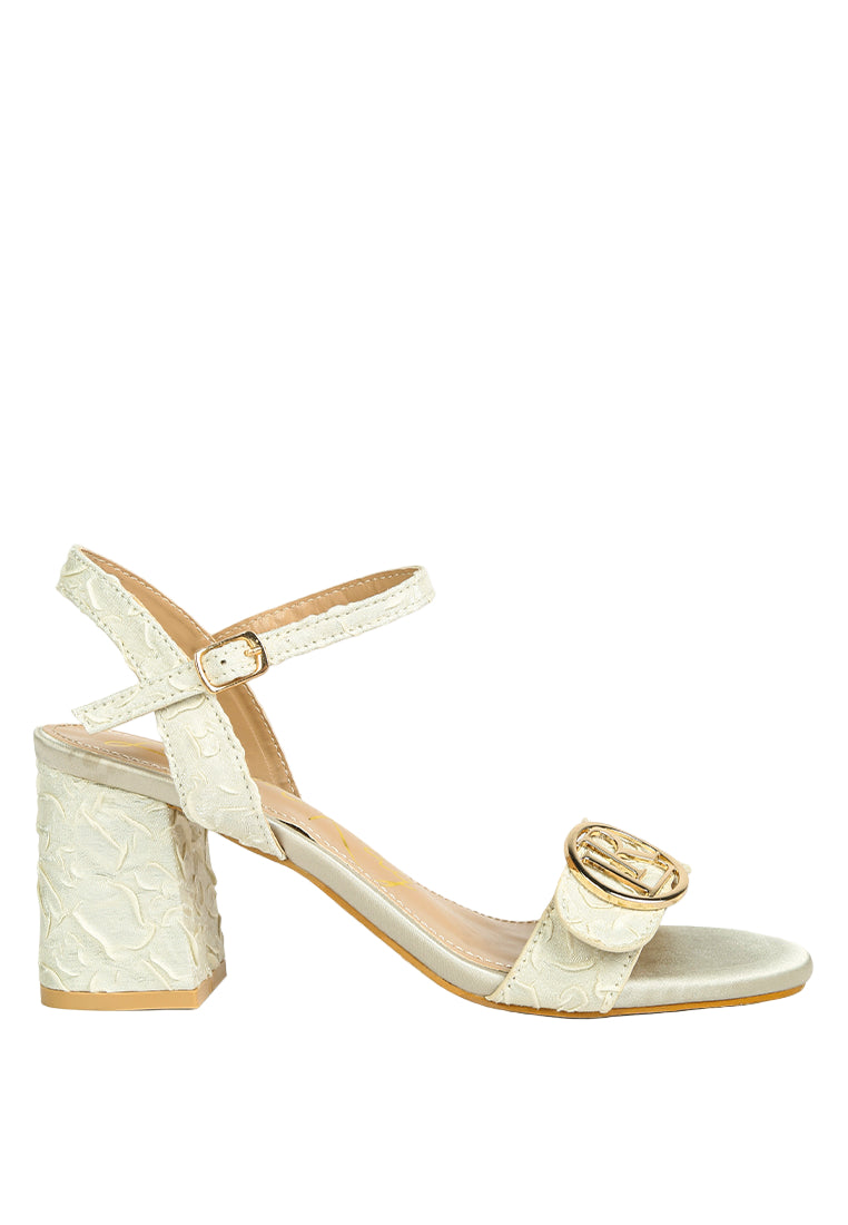 Beige sandal with block heel on a white background