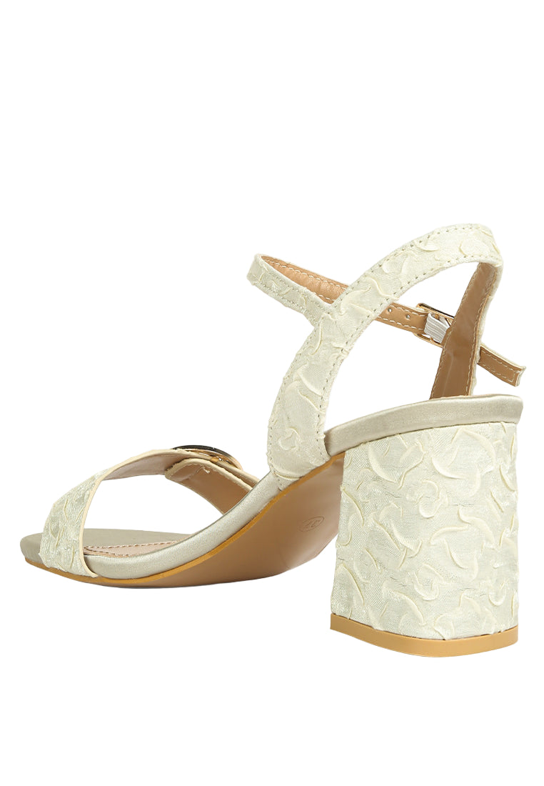 White lace high-heeled sandals on a white background