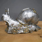 Steampunk-style cement mixer sculpture on a wooden surface with a gray background