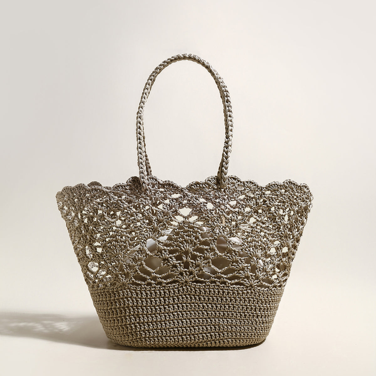 Crocheted handbag with lace detailing on a light background