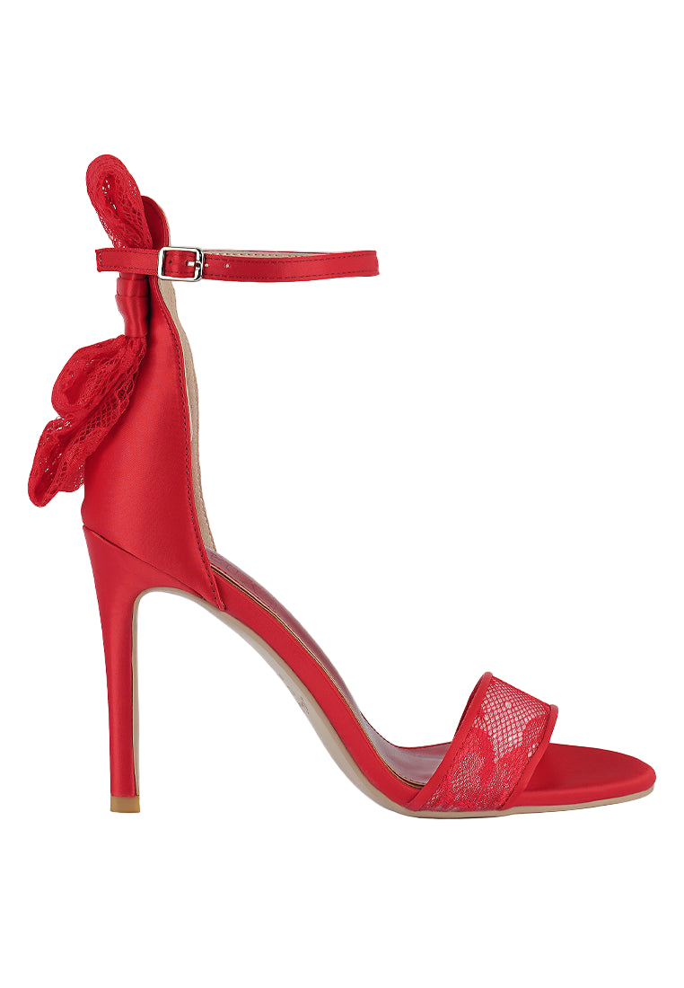Red high-heeled sandal with a bow on a white background