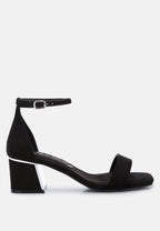 Black sandal with a block heel on a white background