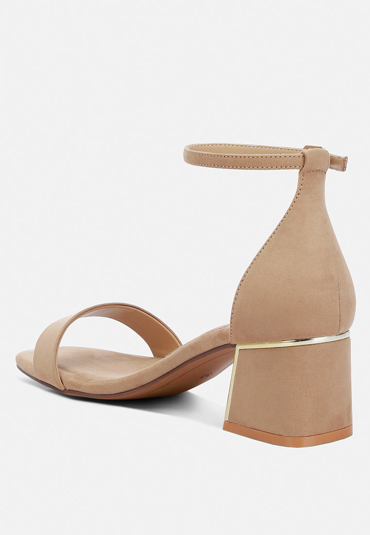 Beige high-heeled sandal with a gold block heel on a white background