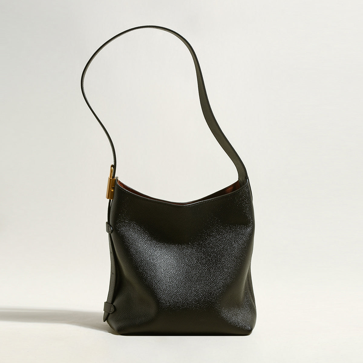 Black leather handbag on a light gray background