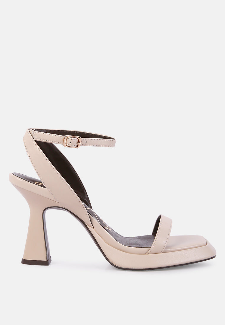 Beige high-heeled sandals on a white background