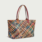 Flamboyant woven leather tote bag showcasing colorful, intricate patterns and sturdy handles for stylish practicality.