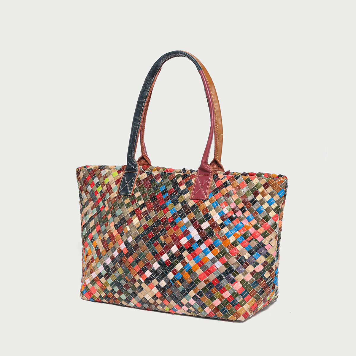 Colorful woven leather tote bag with vibrant patterns, perfect for elevating any outfit.