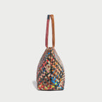 Colorful woven leather tote bag showcasing intricate pattern and stylish handles, perfect for elevating any outfit.