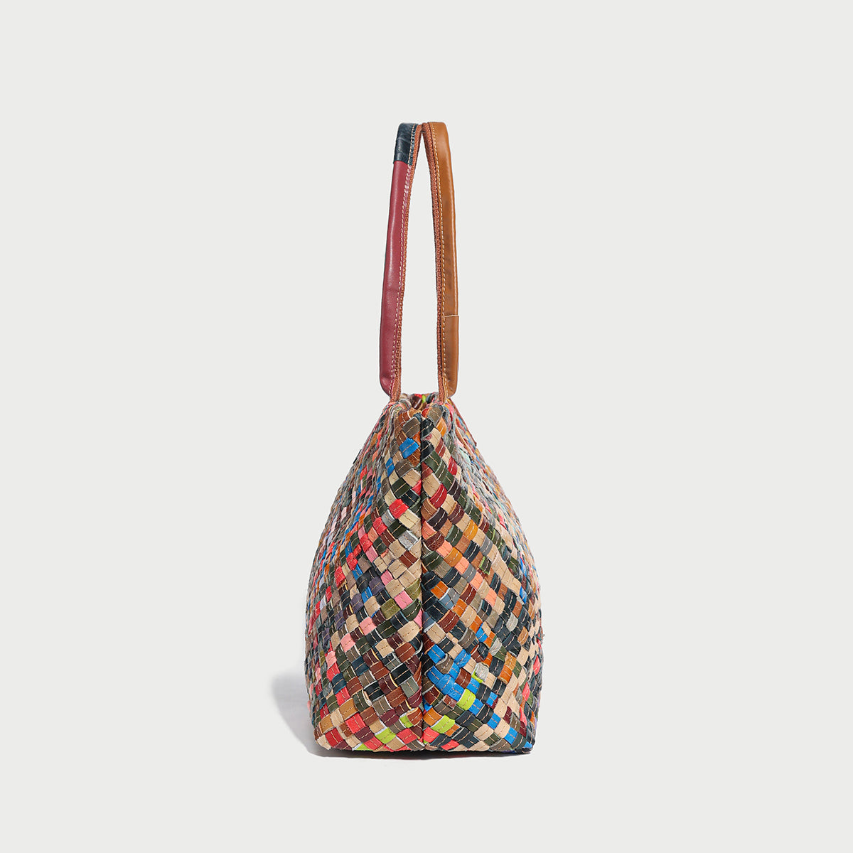 Colorful woven leather tote bag showcasing intricate pattern and stylish handles, perfect for elevating any outfit.