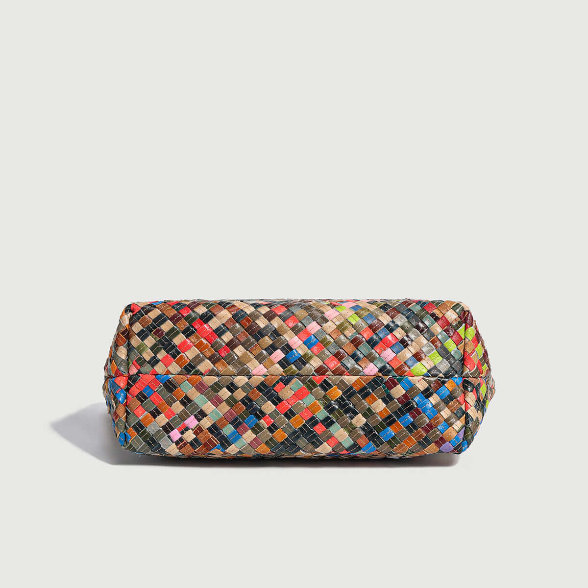 Flamboyant woven leather tote bag with colorful design, showcasing intricate texture and stylish craftsmanship.