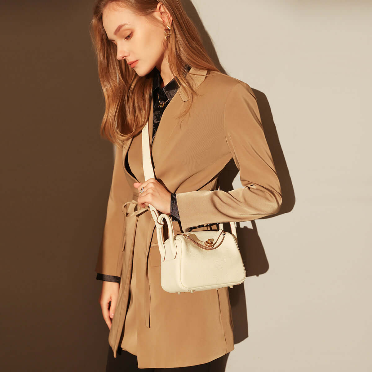 Model showcasing the Monte Convertibile Shoulder Bag in a stylish setting, highlighting its chic design and functionality.