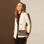 Model showcasing the stylish Monte Convertible Shoulder Bag with a chic white blazer and black outfit.