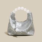 Silver Pearl Top Handle Bag with candy-like oversized pearl handle, perfect for chic occasions and evening events.