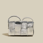 Silver textured handbag on a beige background